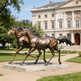Bronze statues of horses in motion, featuring lifelike musculature and flowing hair