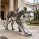 Chrome tiger sculpture in front of a classical building
