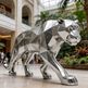 Reflective faceted panther sculpture made from polished metal with a modern abstract style
