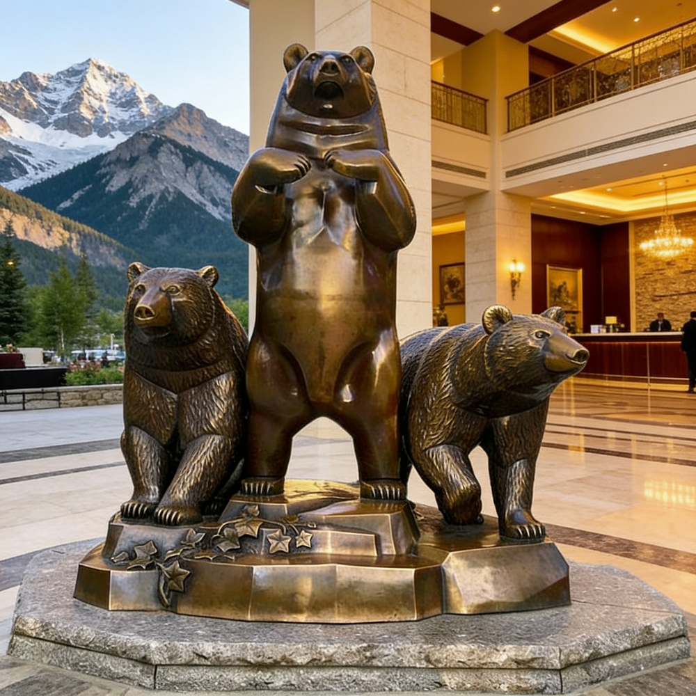 Bronze statue of three bears in a hotel lobby with mountains in the background