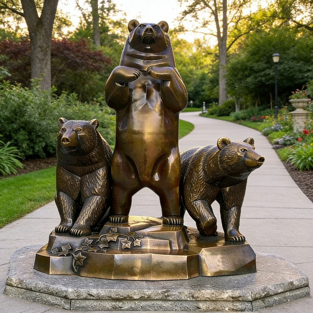 Bronze statue of three bears on a stone pedestal in a garden setting