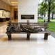 Bronze sculpture of a person on a bench with a quote in an indoor setting.
Bronze artwork depicting a homeless person sleeping on a bench