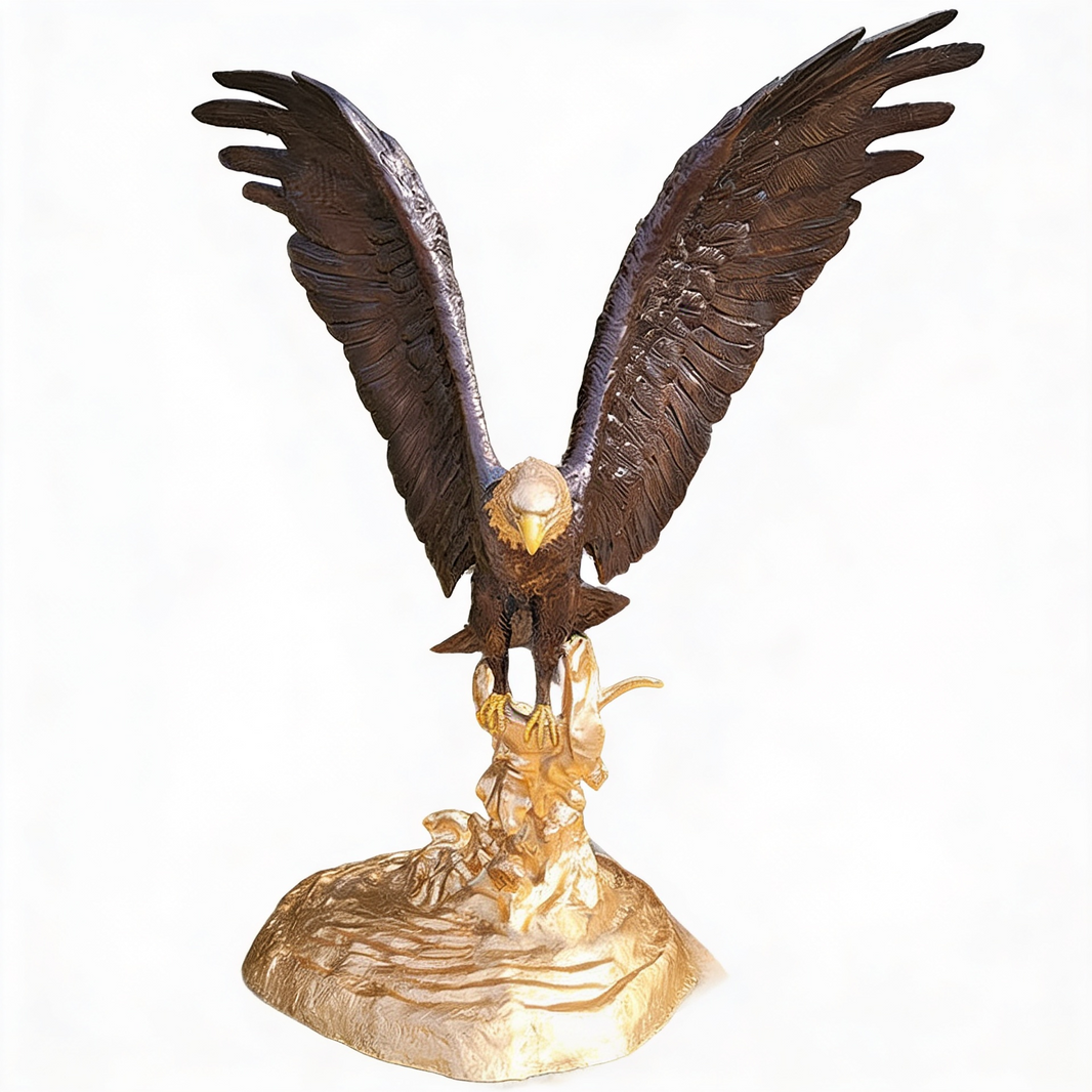 Bronze eagle sculpture with wide outstretched wings standing on a golden rocky base