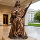 Bronze statue of a religious figure in a public building atrium
Bronze artwork of a standing female saint with hand over heart