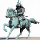 Bronze statue of a samurai on horseback against a white background
Bronze samurai on horseback artwork symbolizing honor and strength