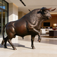 Bronze bull statue in a modern indoor setting
Bronze bull statue in a powerful forward‑leaning stance