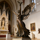 Bronze statue of an angel in a cathedral setting