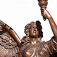 Bronze statue of an angel holding a candle against a white background
Classical bronze statue symbolizing victory and enlightenment