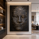 Decorative wall art of a textured face on a black background in a modern interior setting.