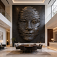 Modern interior with a large wall sculpture of a face in a high-end setting.