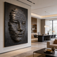 Modern interior with a large abstract sculpture of a face on a wall.