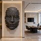 Decorative wall sculpture of a face in a modern interior setting