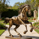 Bronze statue of a horse in a garden setting