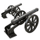 Two black metal cannons on wheels against a white background
Bronze artillery cannon sculpture mounted on carriage