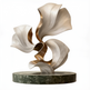 Abstract sculpture with wavy, layered design on a marble base