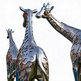 Metallic giraffe sculptures on a white background
Reflective metallic giraffe statues featuring stylized spot patterns