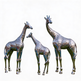 Three metallic giraffe statues on a white background
Shiny giraffe artwork set with realistic proportions and polished finish