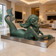 Bronze mermaid statue in a luxurious living room setting