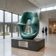 Large abstract sculpture in a museum setting with visitors observing.