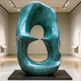 Large teal sculpture in a museum setting