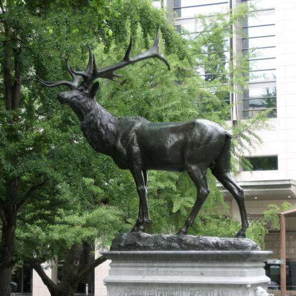 Realistic bronze elk statue featuring detailed fur texture, strong musculature, and carved pedestal base