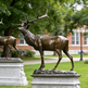 Wildlife‑themed bronze elk sculpture featuring intricate antlers and a sturdy stone pedestal.