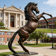 Bronze statue of a horse rearing upward, emphasizing motion, balance, and sculptural detail.
