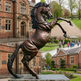 Detailed bronze rearing horse artwork featuring a textured mane and strong dynamic posture