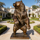 Bronze bear statue in front of a luxurious house