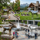 Collage of moose statues in various outdoor settings with people around.