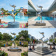Collage of a silver sculpture by a pool with various settings including a water park, modern building, and cityscape.