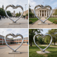 Modern symbolic sculpture of a heart formed by two hands, mounted on a pedestal in an institutional setting