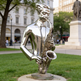 Contemporary abstract saxophone sculpture with mirrored surfaces and stylized human elements