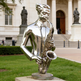 Contemporary abstract saxophone sculpture with mirrored surfaces and stylized human elements