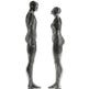 Contemporary metal artwork with hollow ring‑constructed human figures