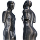 Polished metal sculpture of two human figures formed from stacked circular rings