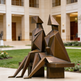 Abstract bronze sculpture of two figures on a bench in front of a building
Reflective metal sculpture featuring two stylized seated figures in abstract form