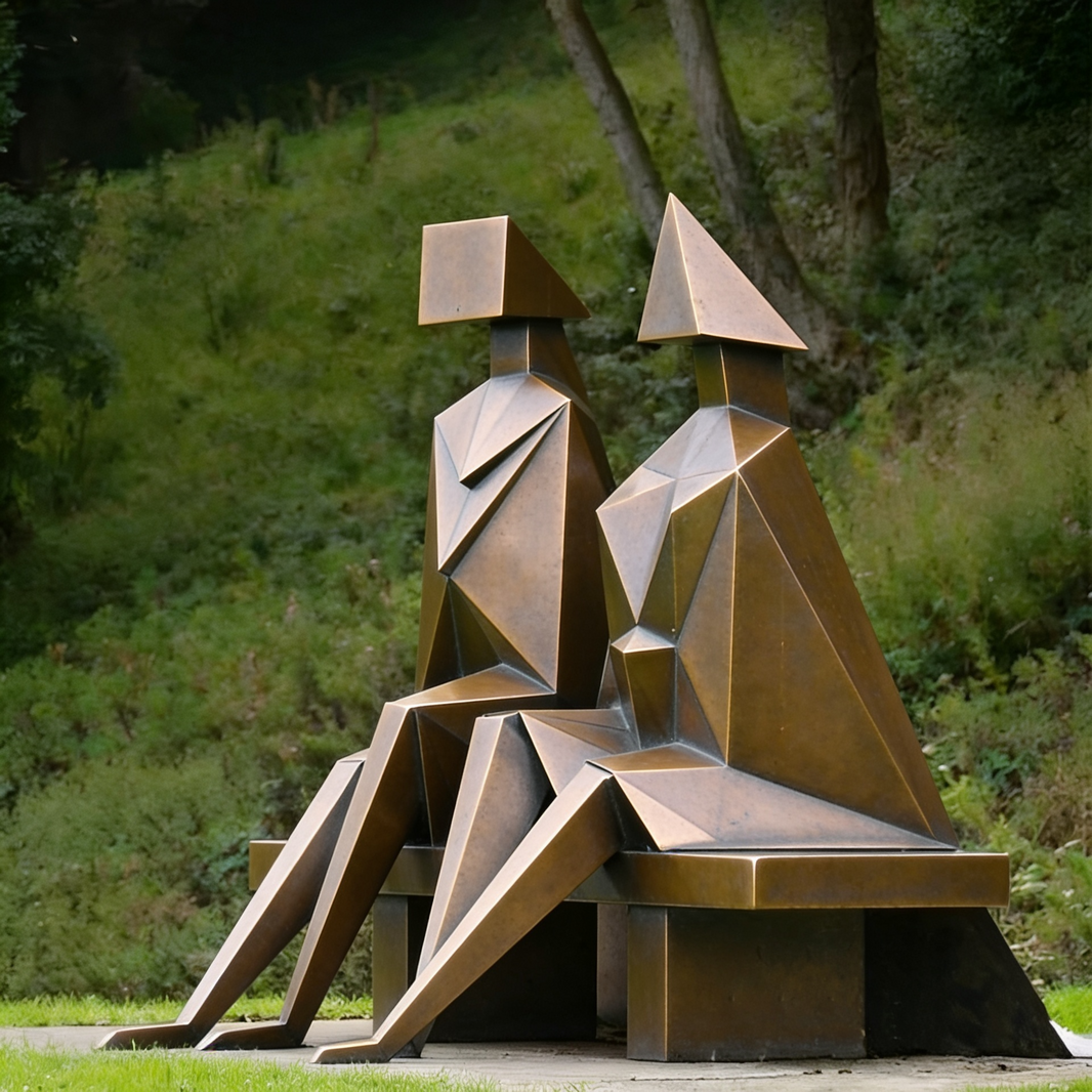 Bronze sculpture of two abstract figures sitting on a bench in a natural setting