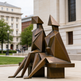 Abstract bronze sculpture of two figures on a pedestal in an urban setting
Contemporary metal artwork showing two seated figures with cubist‑style shapes