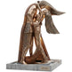 Bronze sculpture of two figures embracing on a white background
Bronze geometric sculpture of two abstract human figures embracing on a solid base
