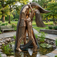 Bronze sculpture of a woman by a pond in a park setting
Modern abstract embrace sculpture with faceted surfaces and elongated human forms