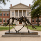 Contemporary bronze horse statue with fragmented skeletal design displayed in an outdoor setting