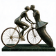 Bronze sculpture of a couple on a bicycle on a white background