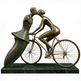 Bronze sculpture of a man and woman on a bicycle with a green base
Romantic bronze sculpture featuring a cyclist and abstract partner