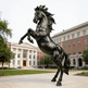 Bronze horse statue in front of a building with a clear sky
Metal stallion statue rising on hind legs in dynamic pose