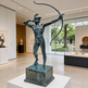 Lifesize bronze figure holding a bow in a dramatic pose