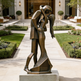Bronze sculpture of a couple embracing in an outdoor garden setting
