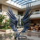 Large metal sculpture of wings in a modern indoor setting with plants and furniture.
