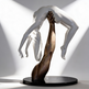 Modern artwork featuring a bronze arm lifting a glossy white figure with flowing hair.