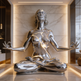 Metallic sculpture of a meditating figure in a modern interior setting